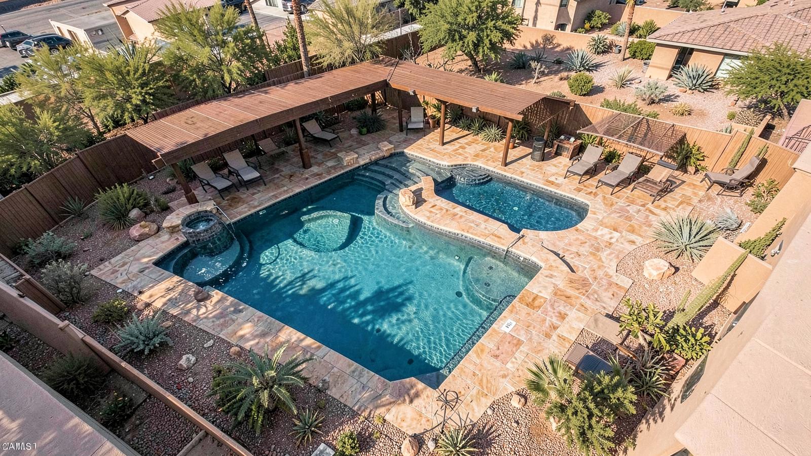Overhead view of a Las Vegas backyard with a custom pool, spa, shade structure and desert landscaping